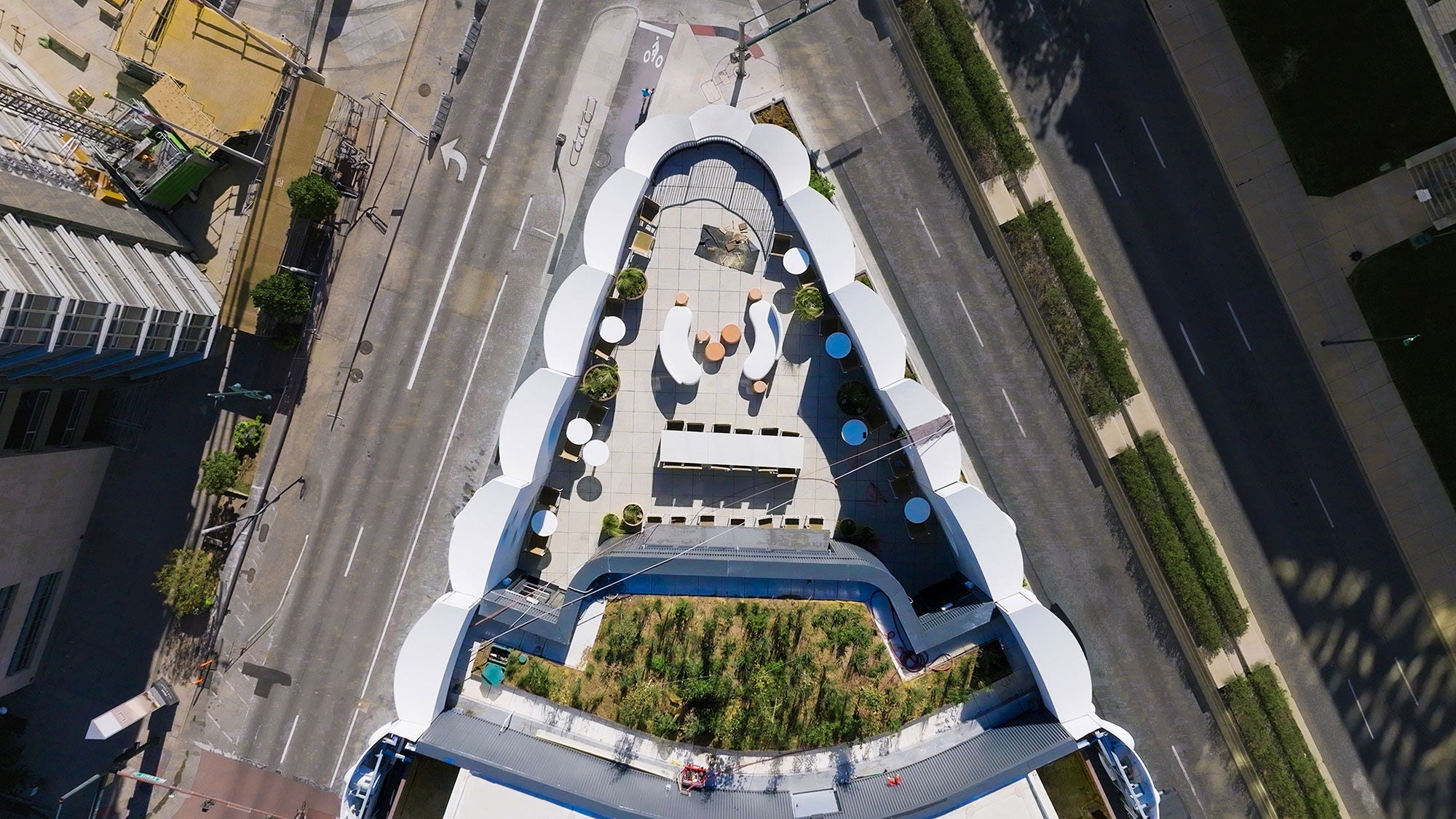 A wider aerial view of Populus’s rooftop terrace and green roof, looking down toward the street.