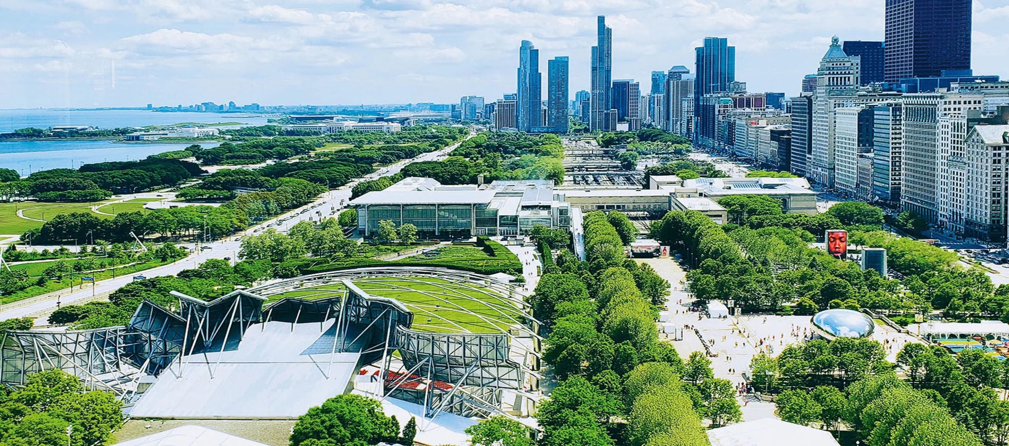 Aerial view of Maggie Daley Park in Chicago with city skyline and greenery