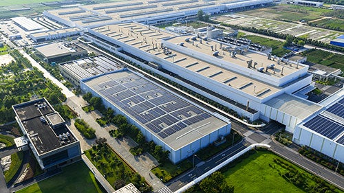 A collection of large rectangular buildings of a data center as seen from above