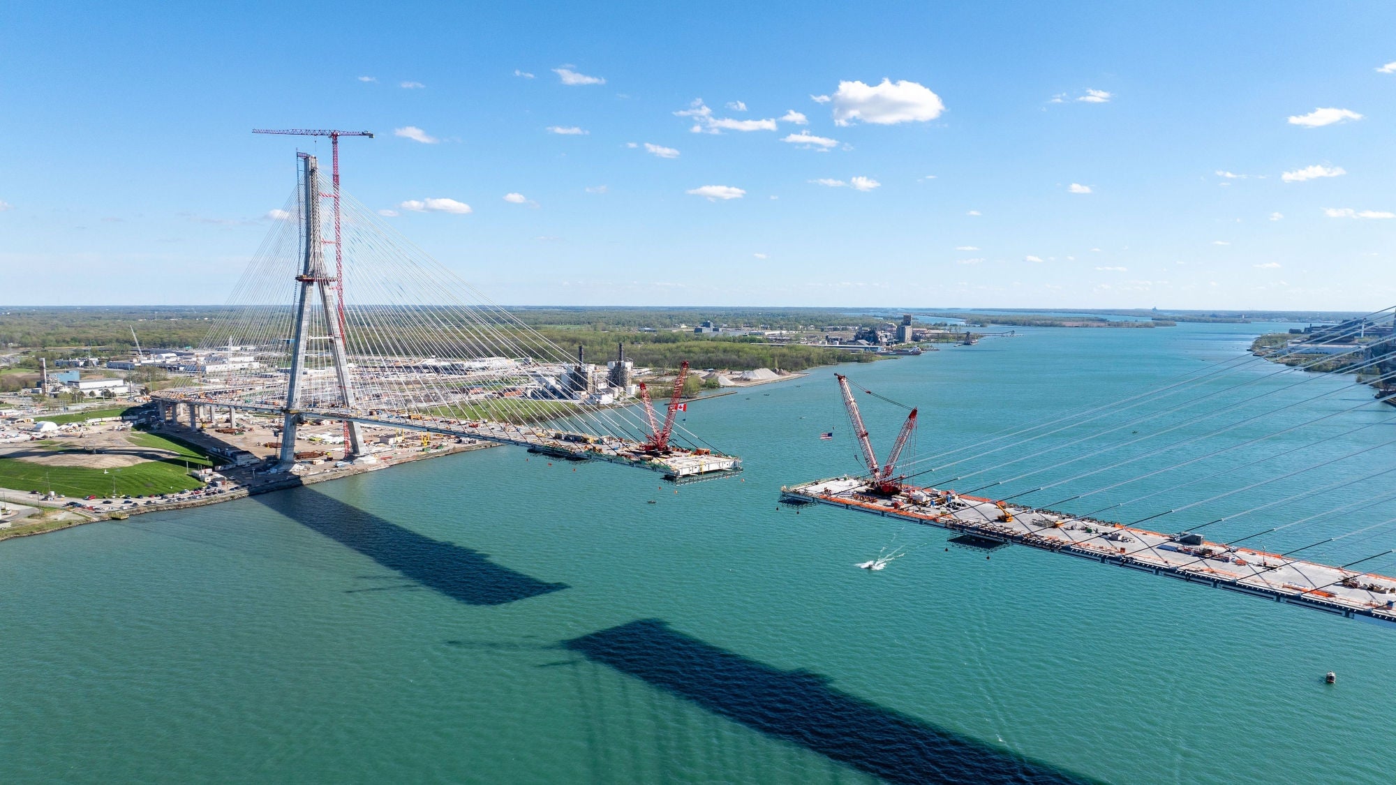 Aerial view of the Gordie Howe International Bridge deck gap during construction over the Detroit River.
