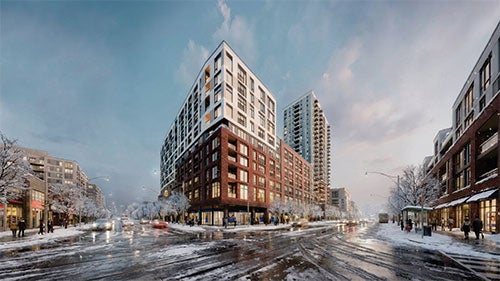 A large residential building of concrete on a street corner in the midst of an urban winter scene