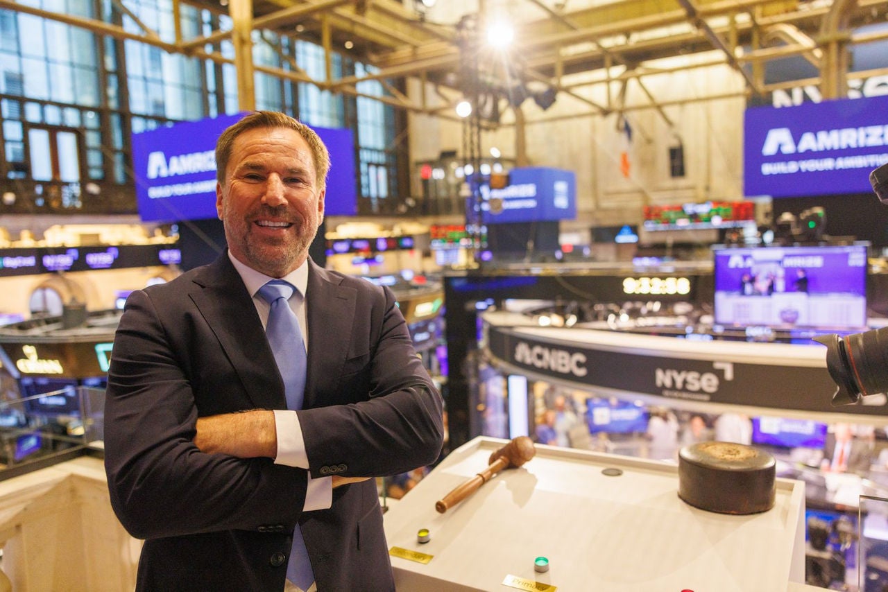 The CEO of Amrize stands on a podium overlooking the NYSE trading floor