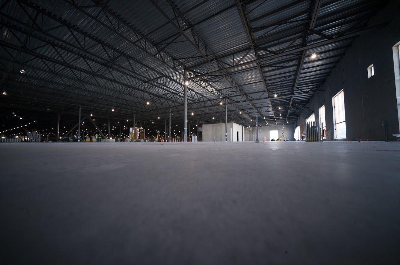 Looking across the floor of a vast warehouse