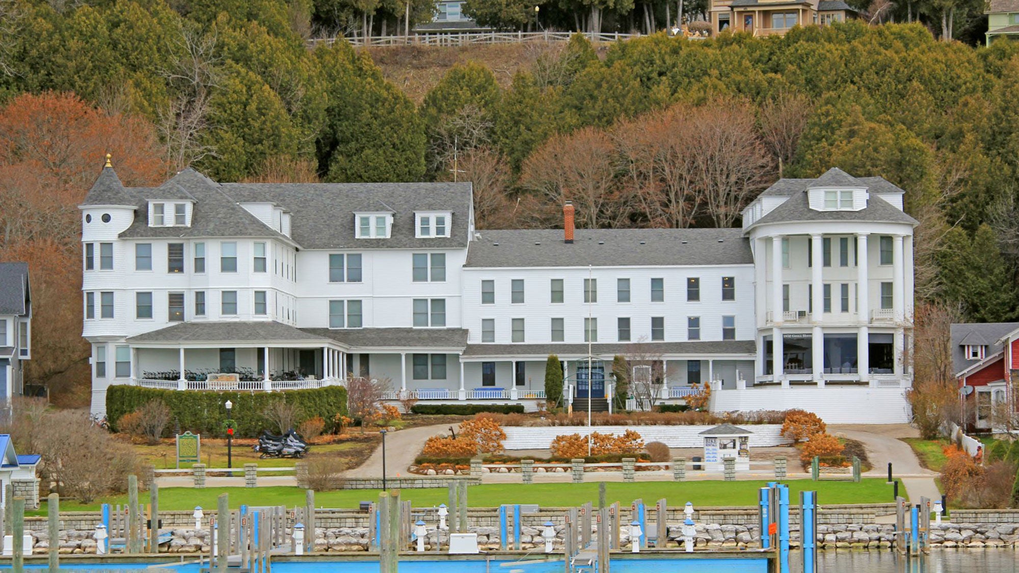 The Island House Hotel, a white building on a lake with nearby docks.