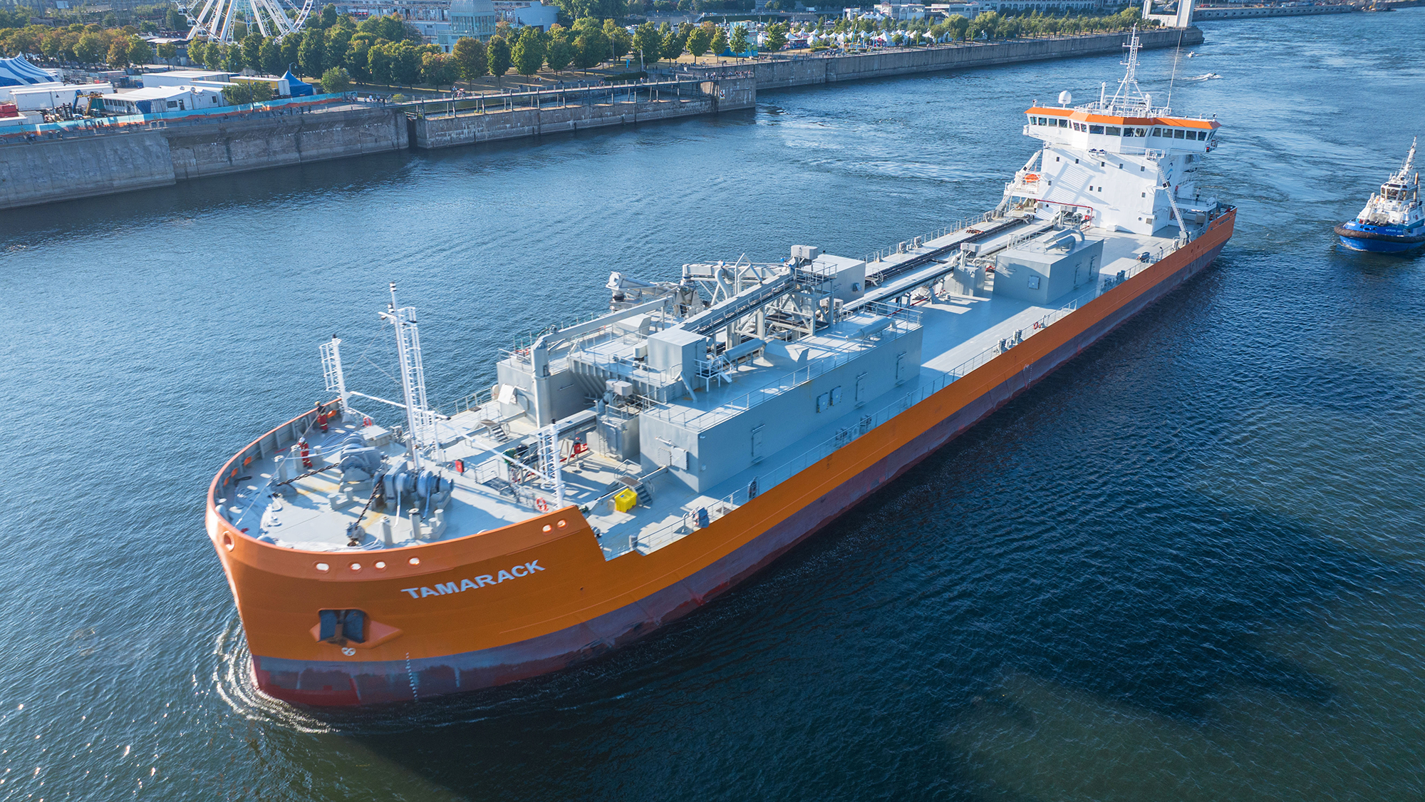 An aerial view of a large ship floating down a river