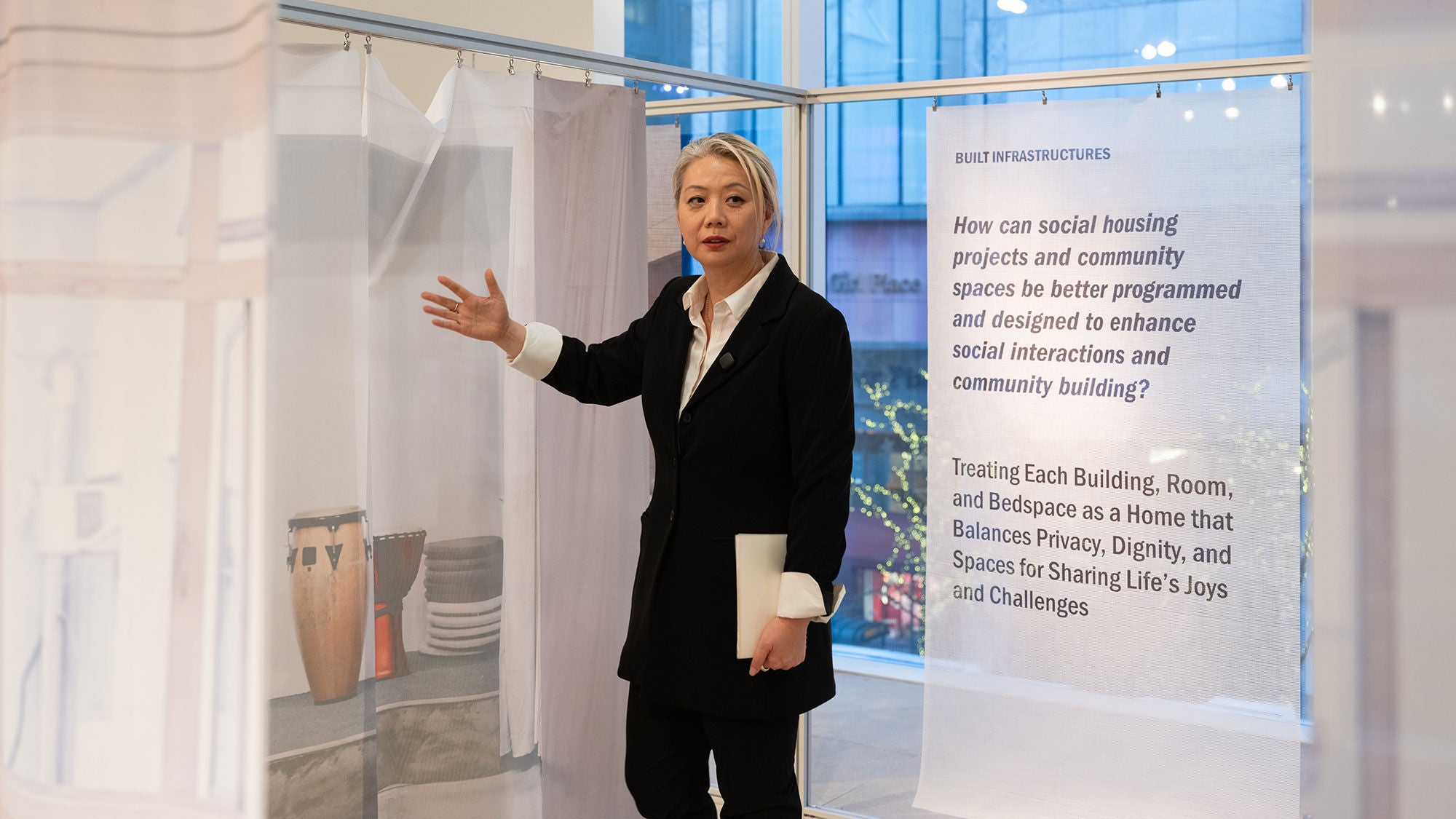 A woman stands in front of an exhibit showcasing its features.