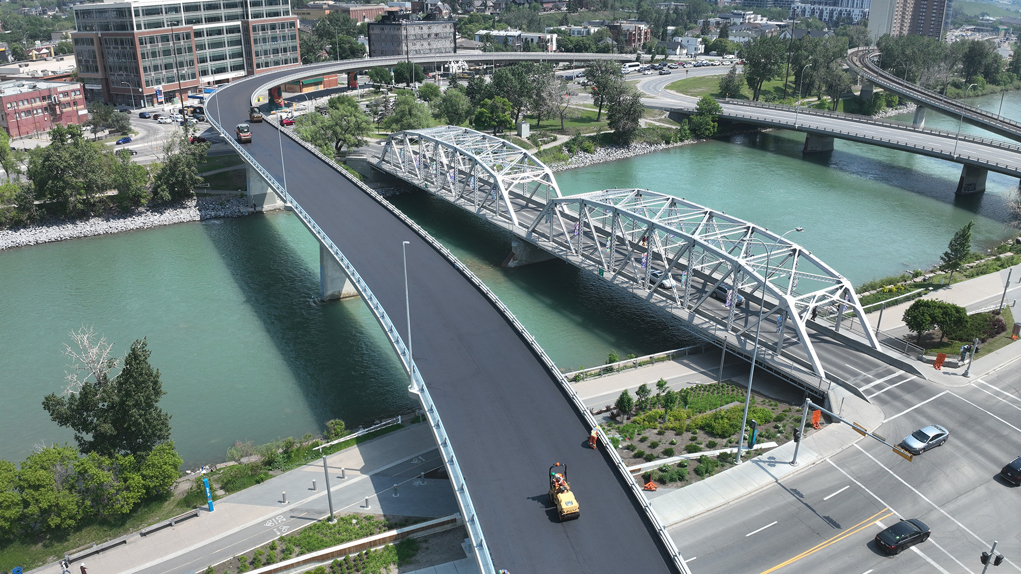An aerial view of a bridge over a river with a fresh coat of asphalt