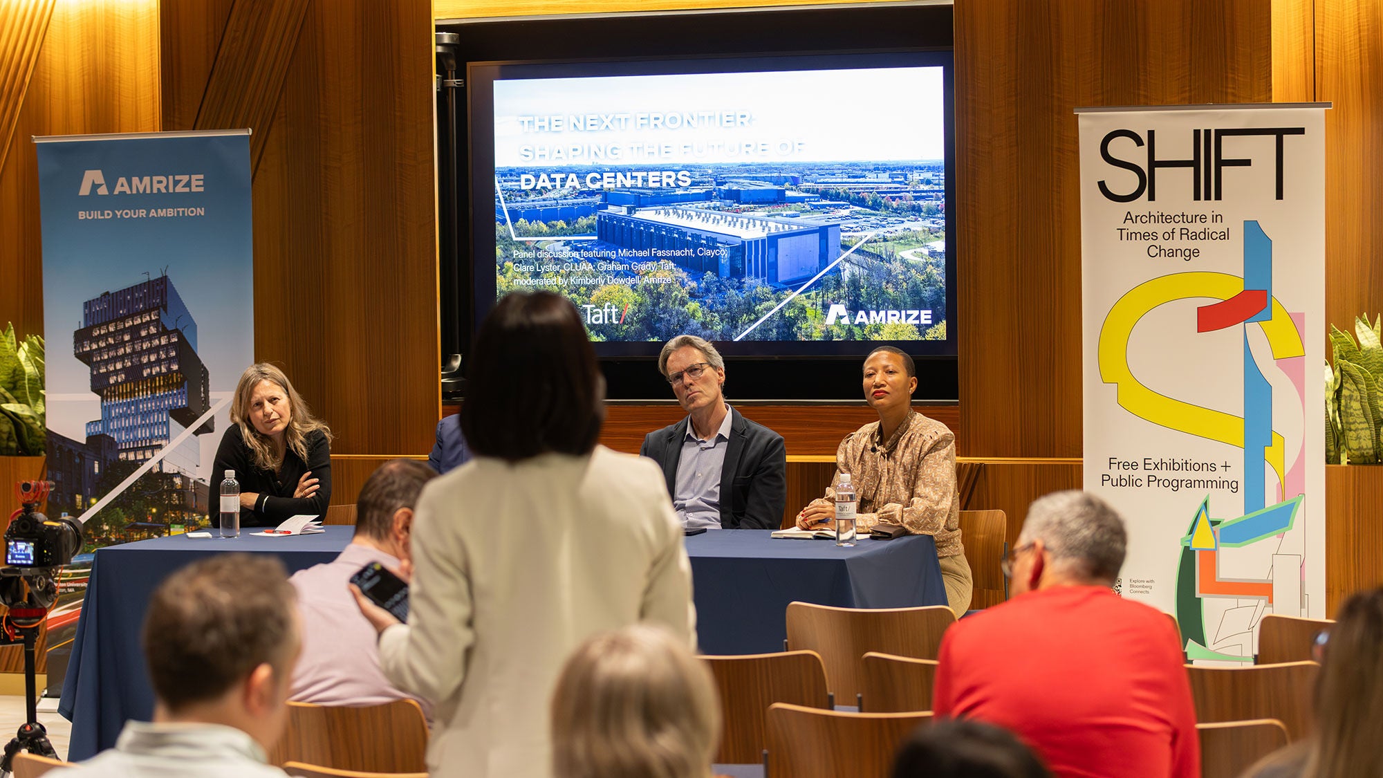 Four panelists sit in front of a screen answering questions from the audience at a Chicago Architecture Biennial event.