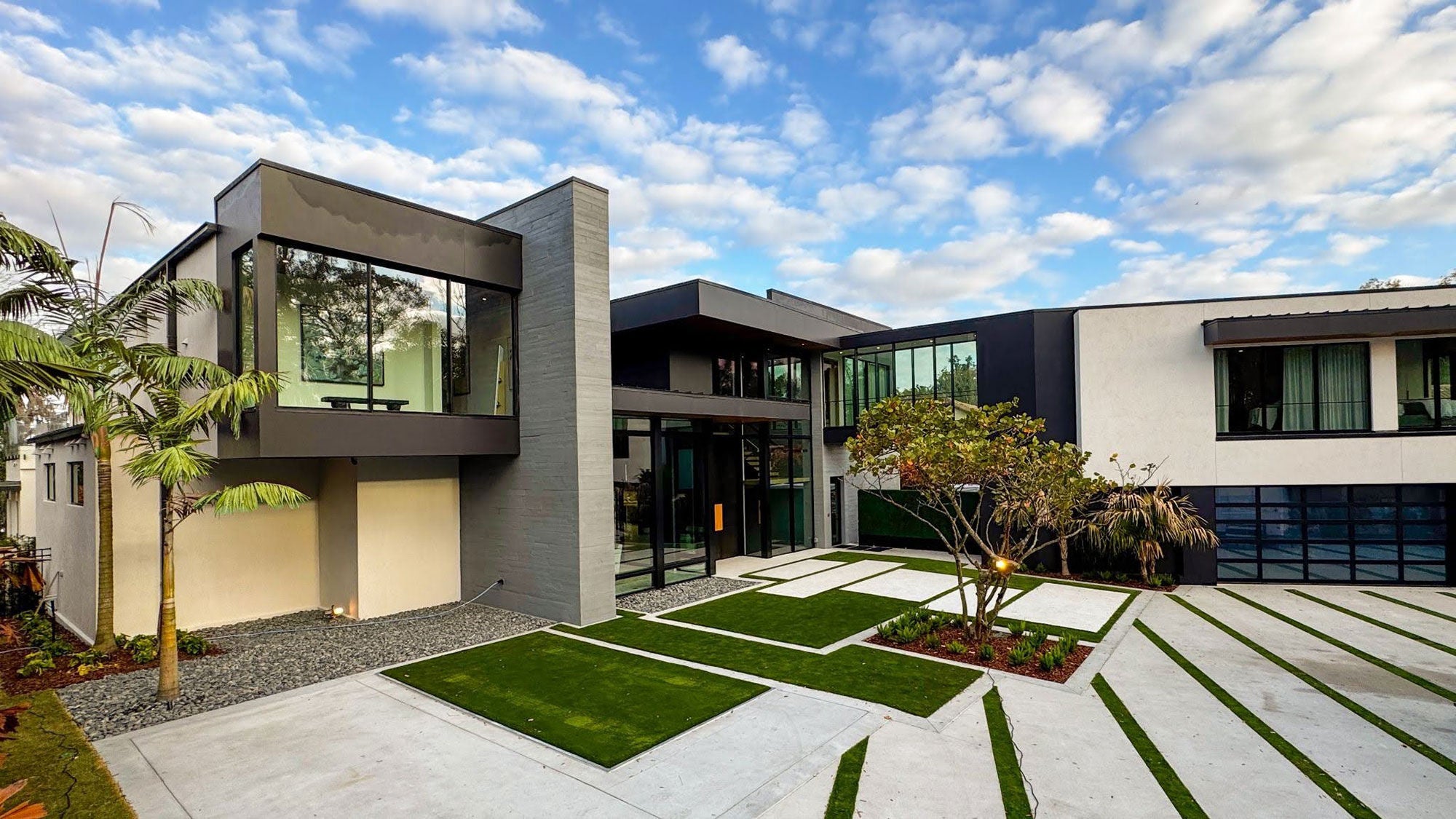 Exterior view of The New American Home 2026, a two-story modern luxury residence in Winter Park, Florida, overlooking Lake Osceola.