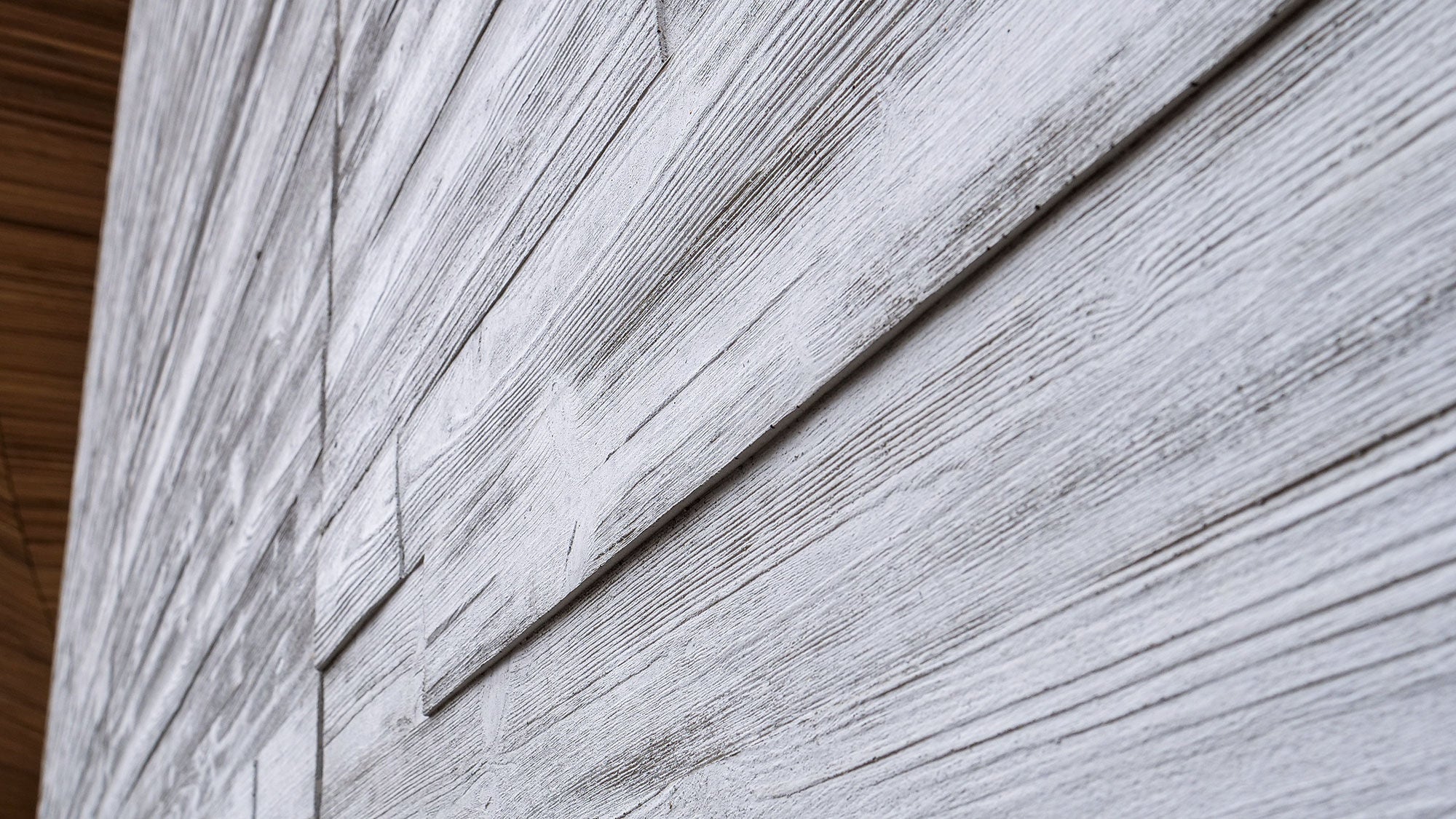 Extreme close-up of the highly detailed texture on Amrize precast concrete panels.