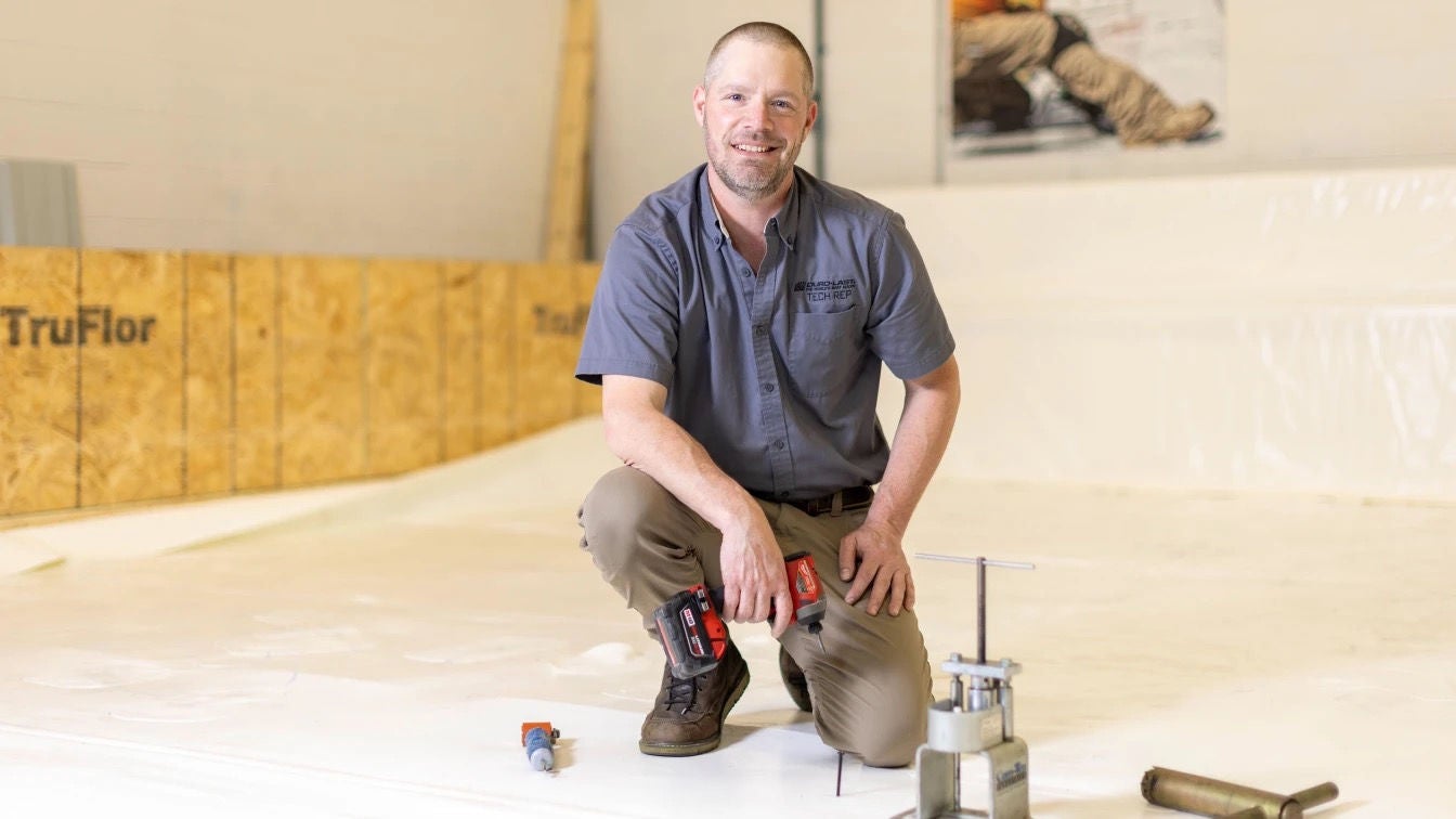 A veteran holding a drill on a job site