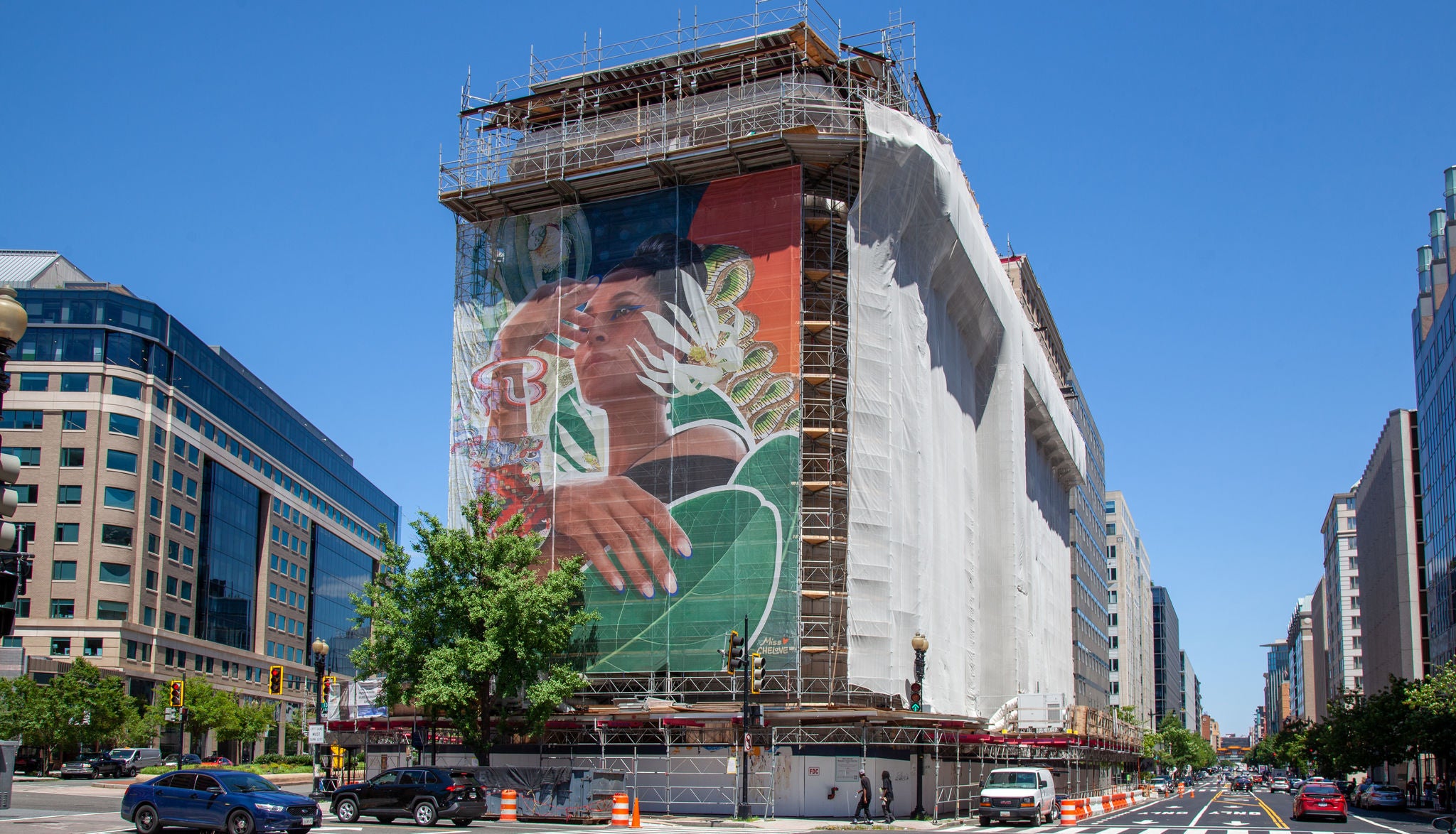 A building exterior draped for renovation