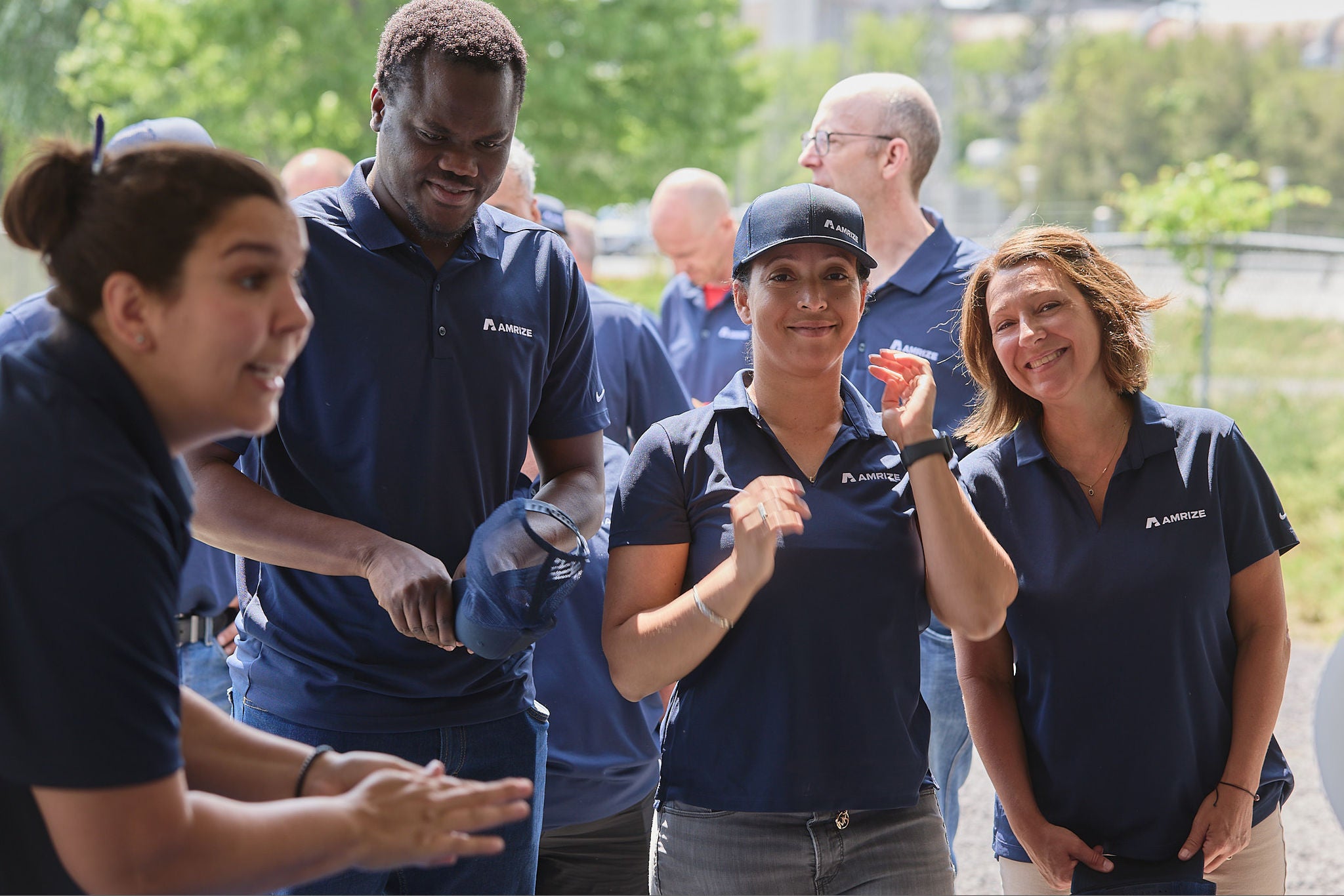 A group of employees giving thumbs up