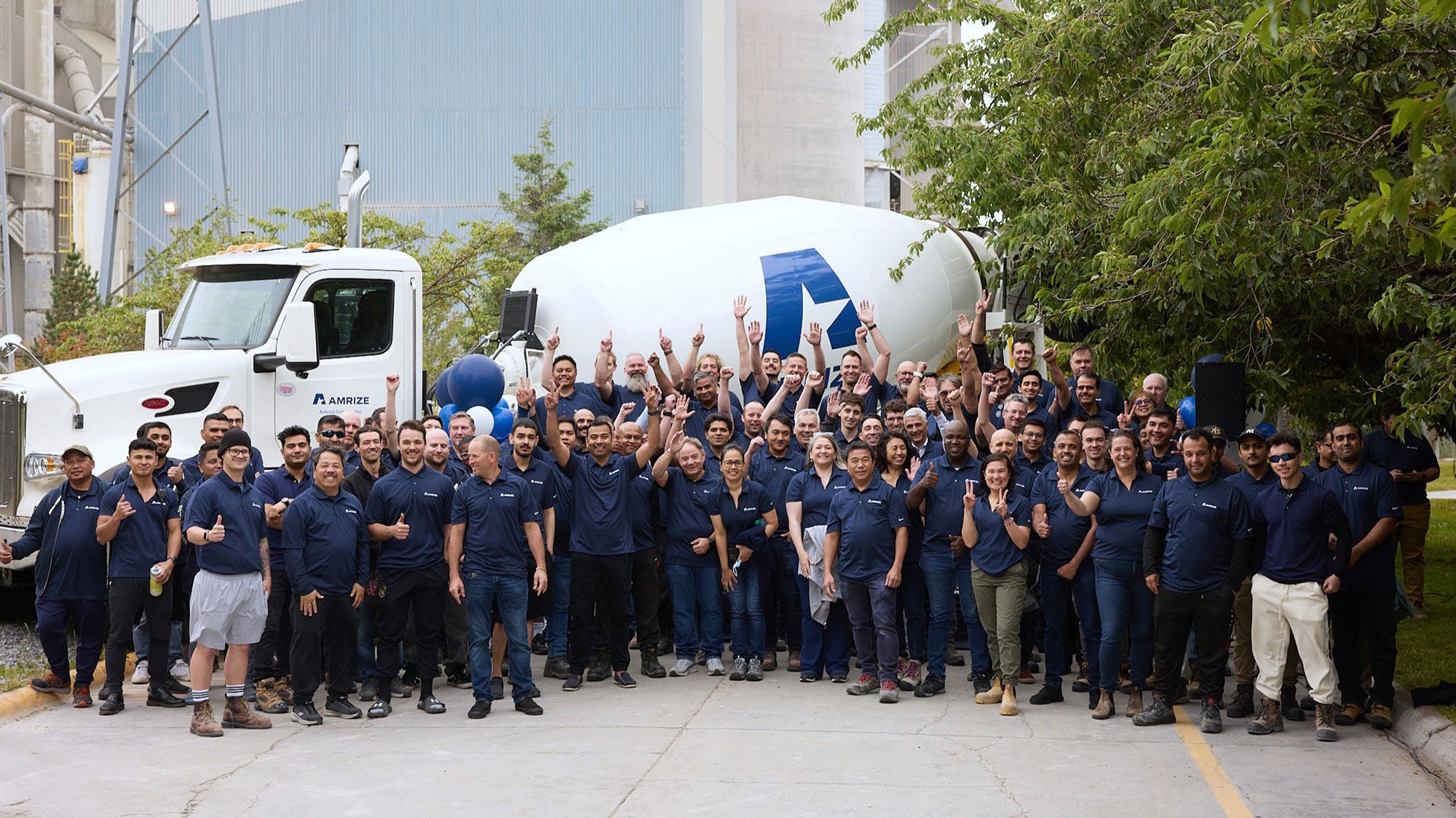 Amrize company team photo in front of a concrete truck at their Richmond plant.