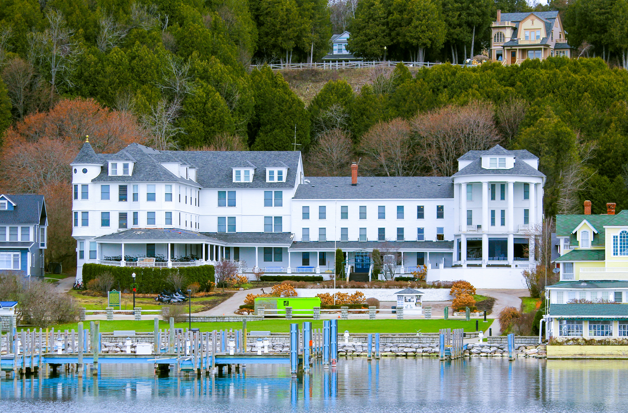 A Victorian-era hotel on the waterfront with trees behind
