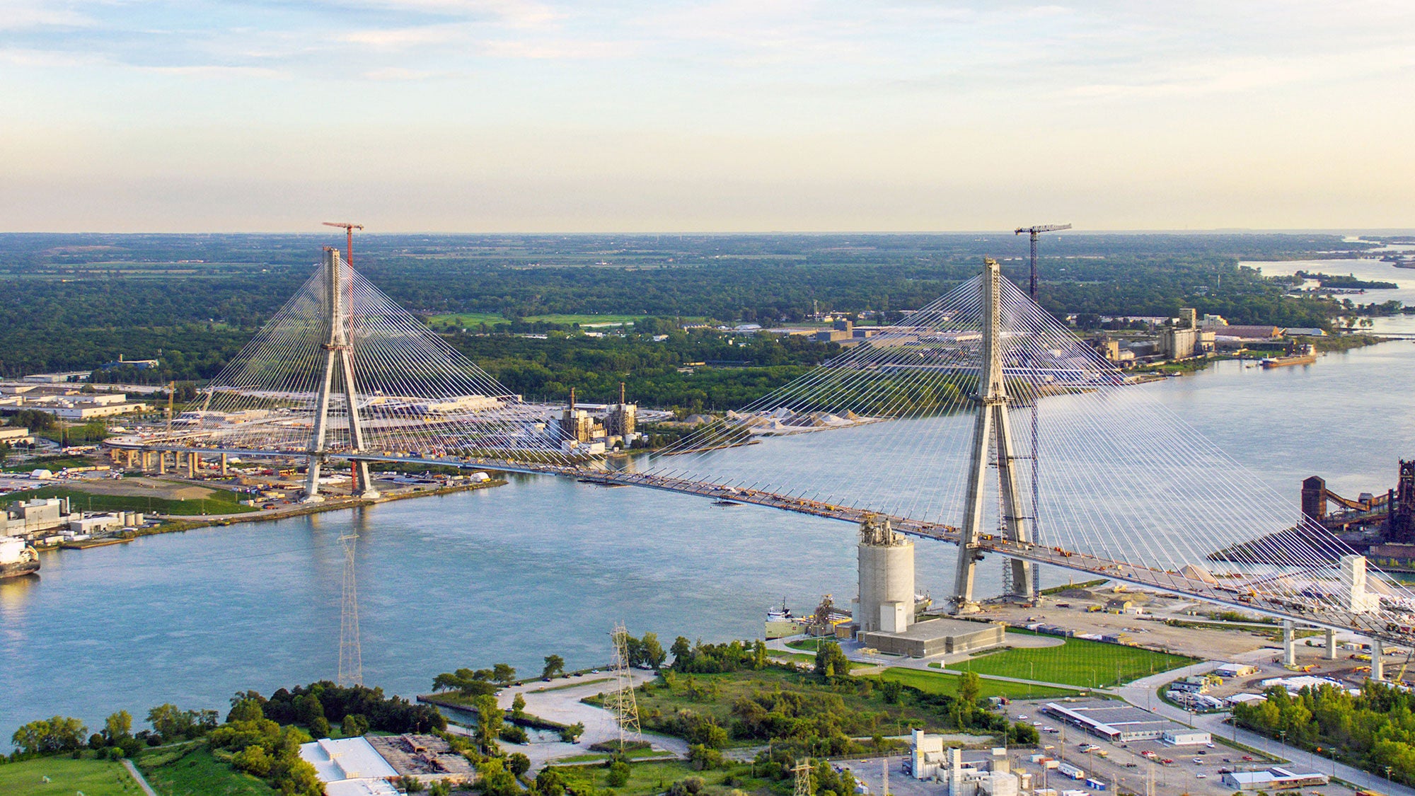 High aerial view showing the Gordie Howe International Bridge bridging Canada and the United States over the Detroit River.