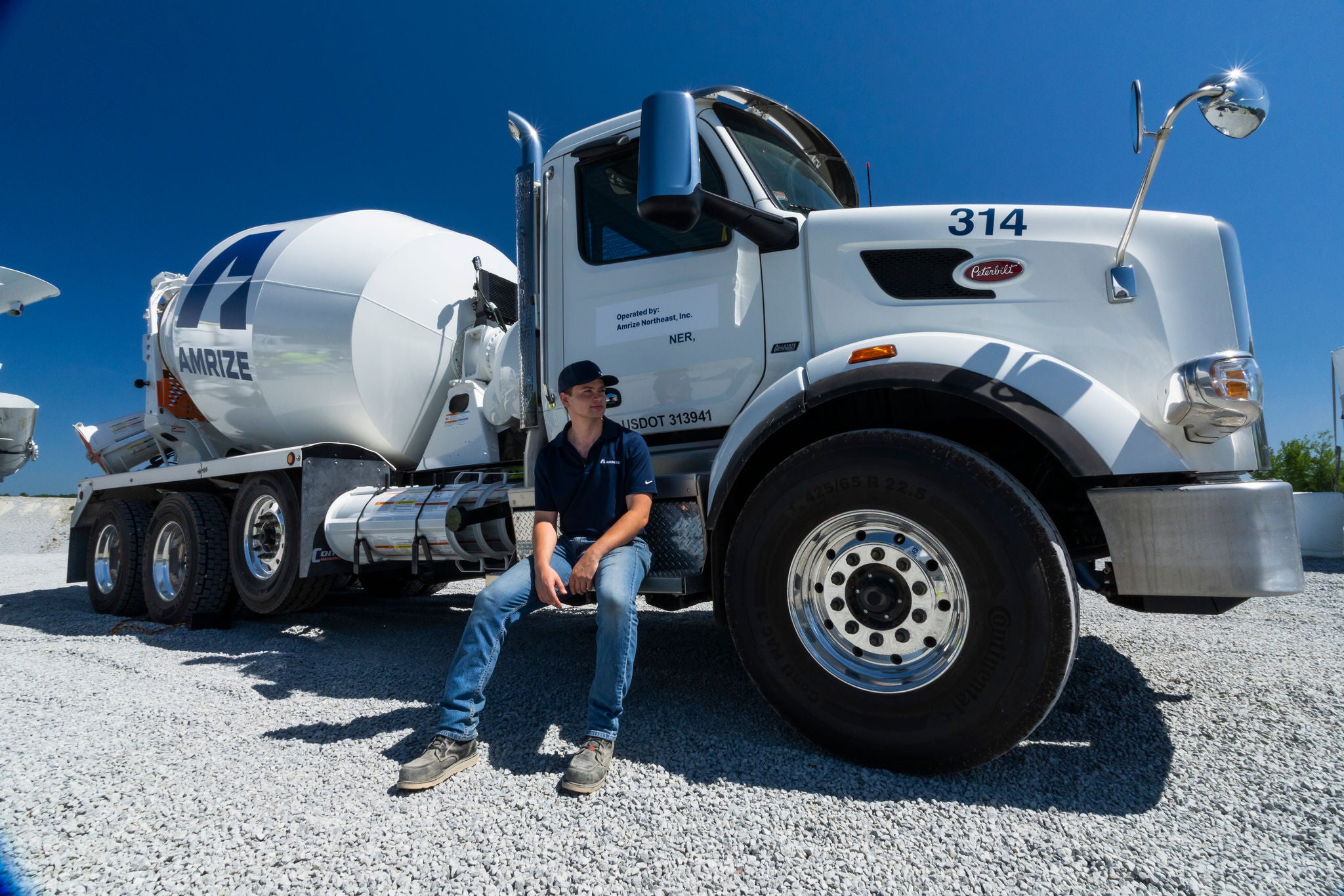 Man sitting on step of cement truck