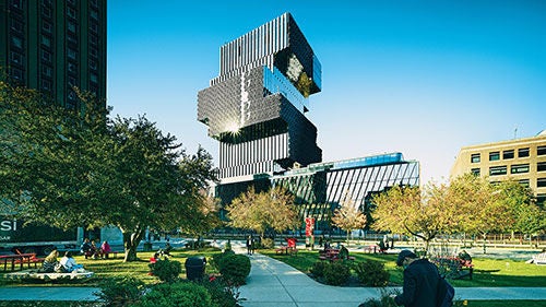 A large angular modern building rises over a green park