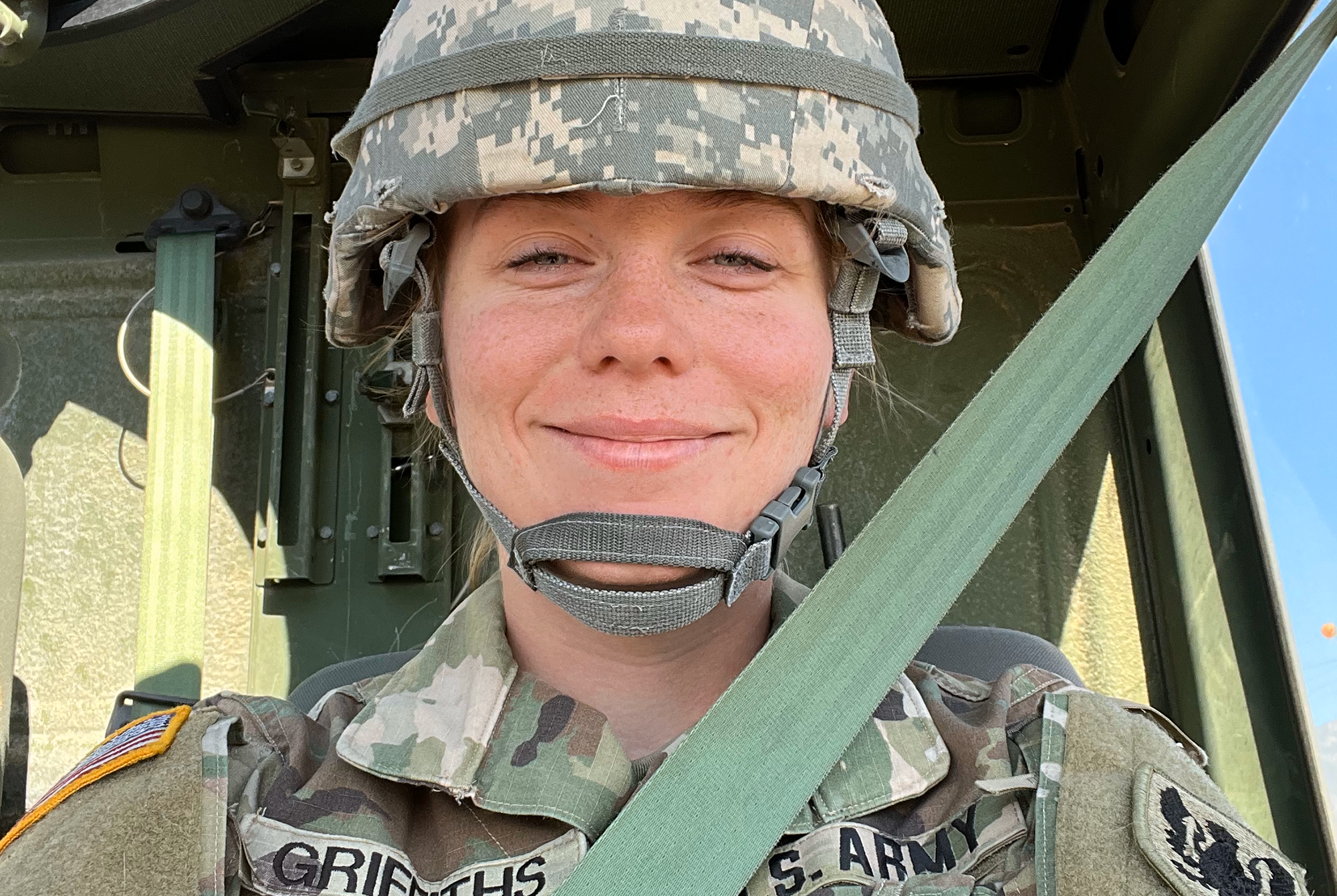 A female member of the U.S. Army Reserve smiles at the camera