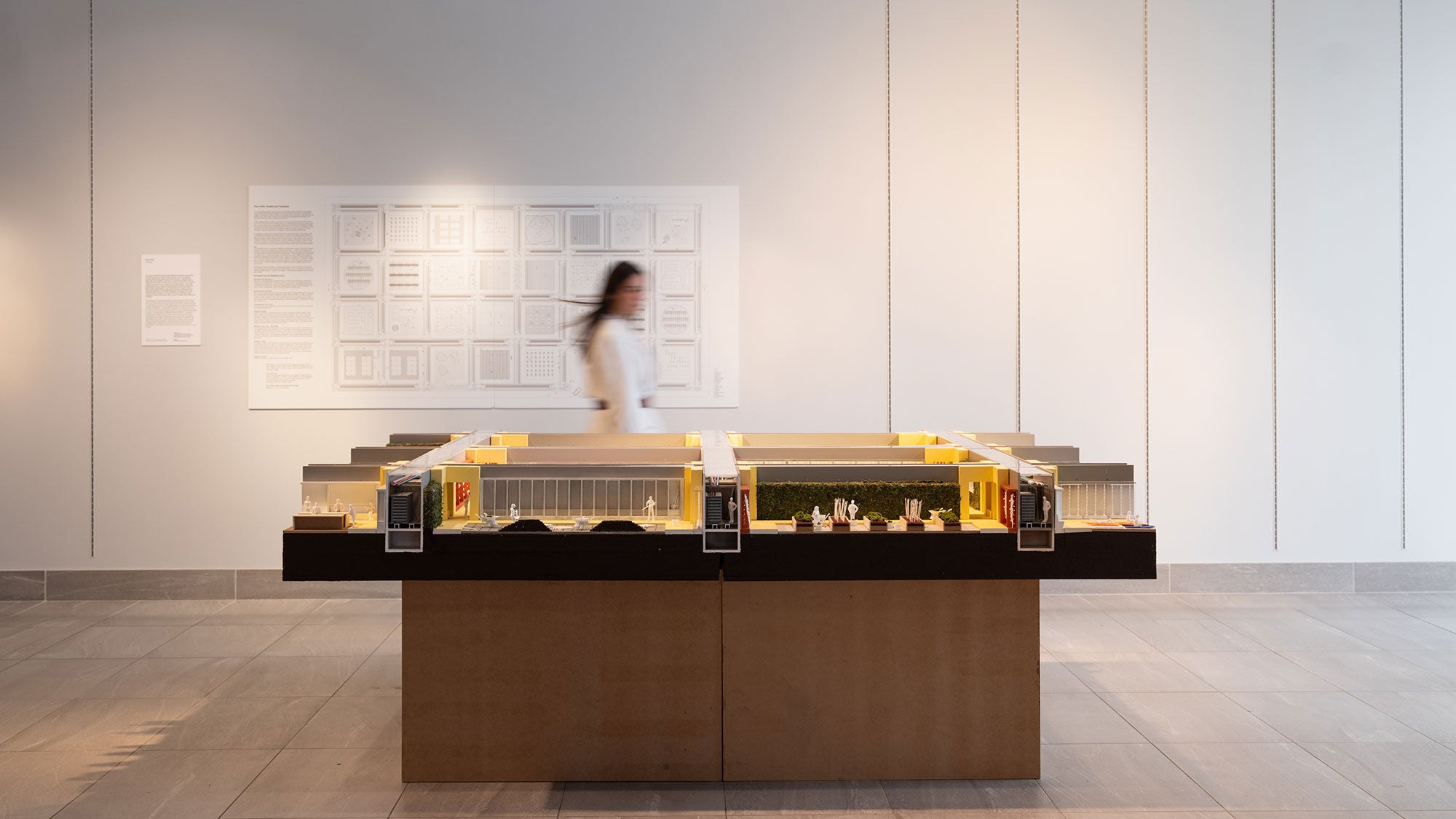 A guest at an architecture exhibition walks past a data center exhibit.