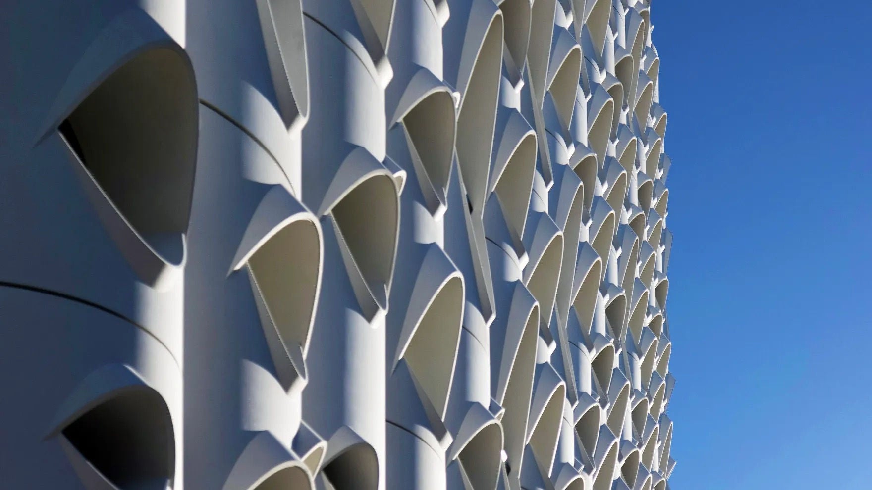 Close-up, Populus facade with distinctive teardrop-shaped openings 