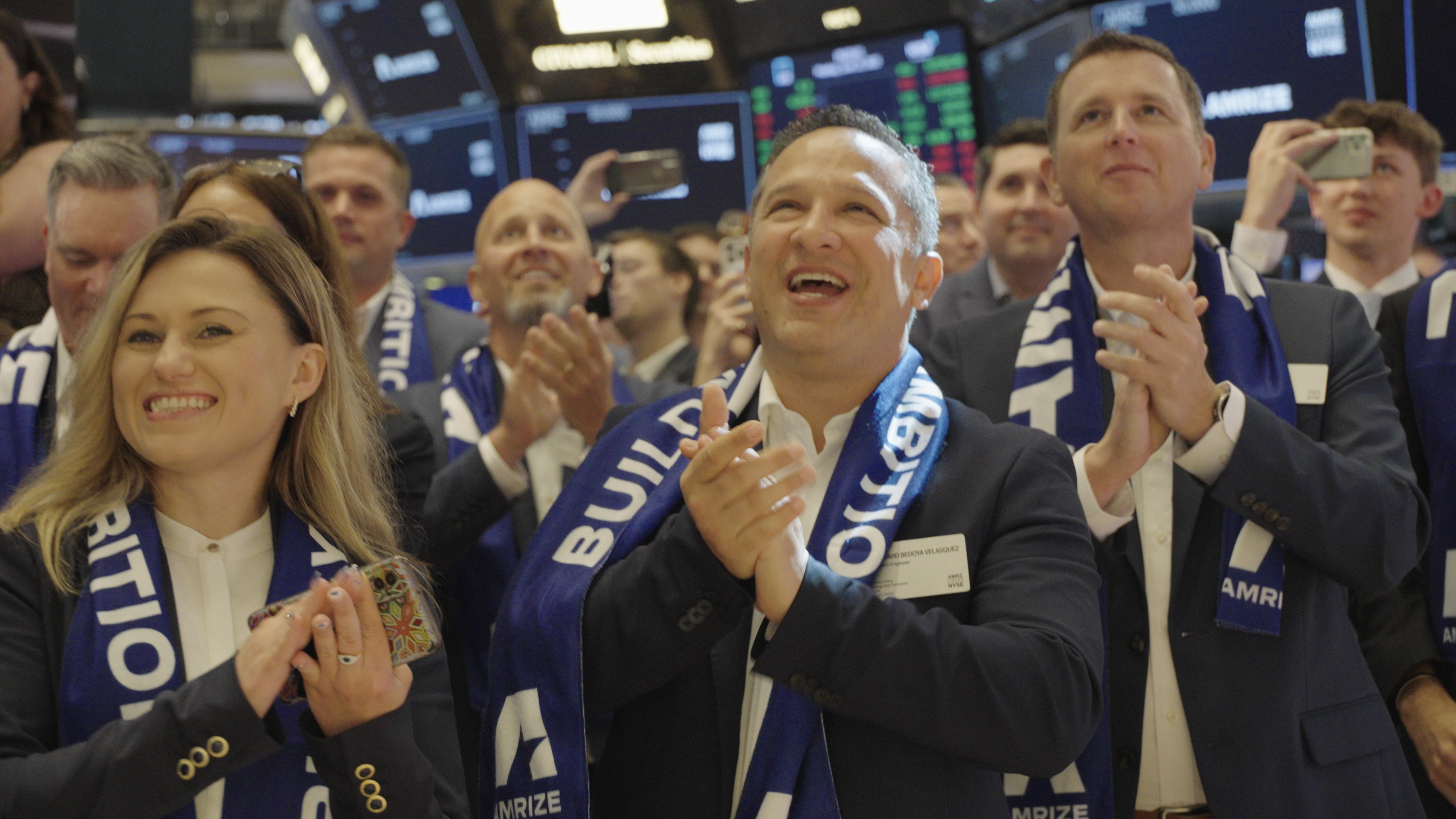 A group of employees clapping and smiling