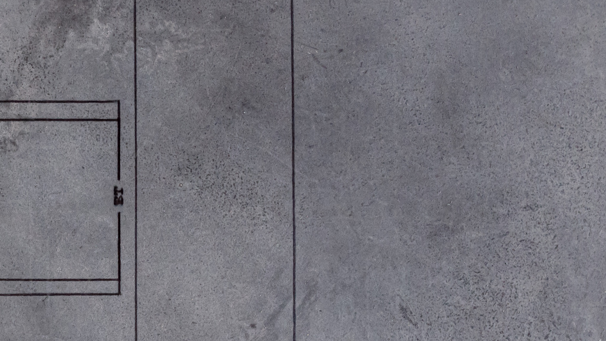 Close-up of a concrete floor with markings on it