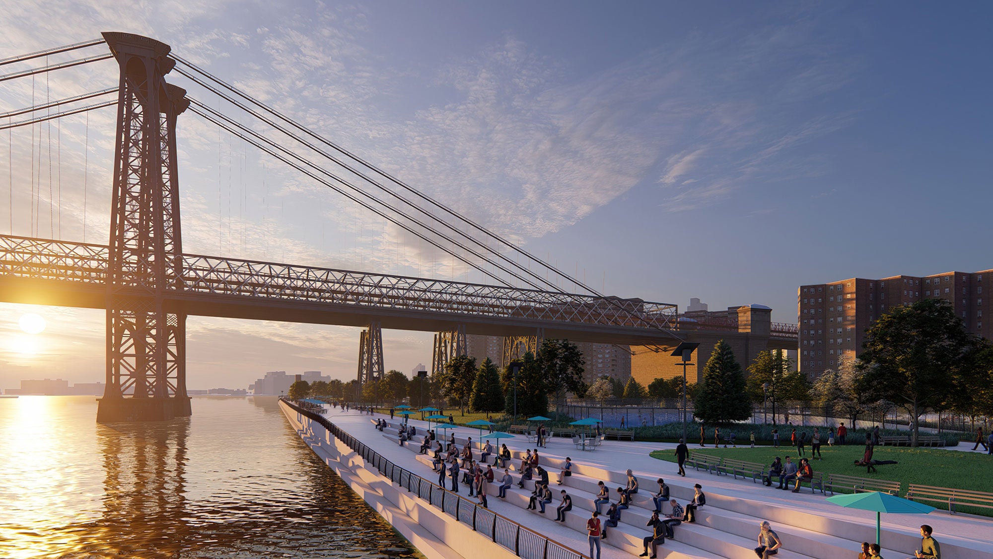 Waterfront promenade at sunset featuring concrete terraced seating with people relaxing next to the East River and the Williamsburg Bridge.