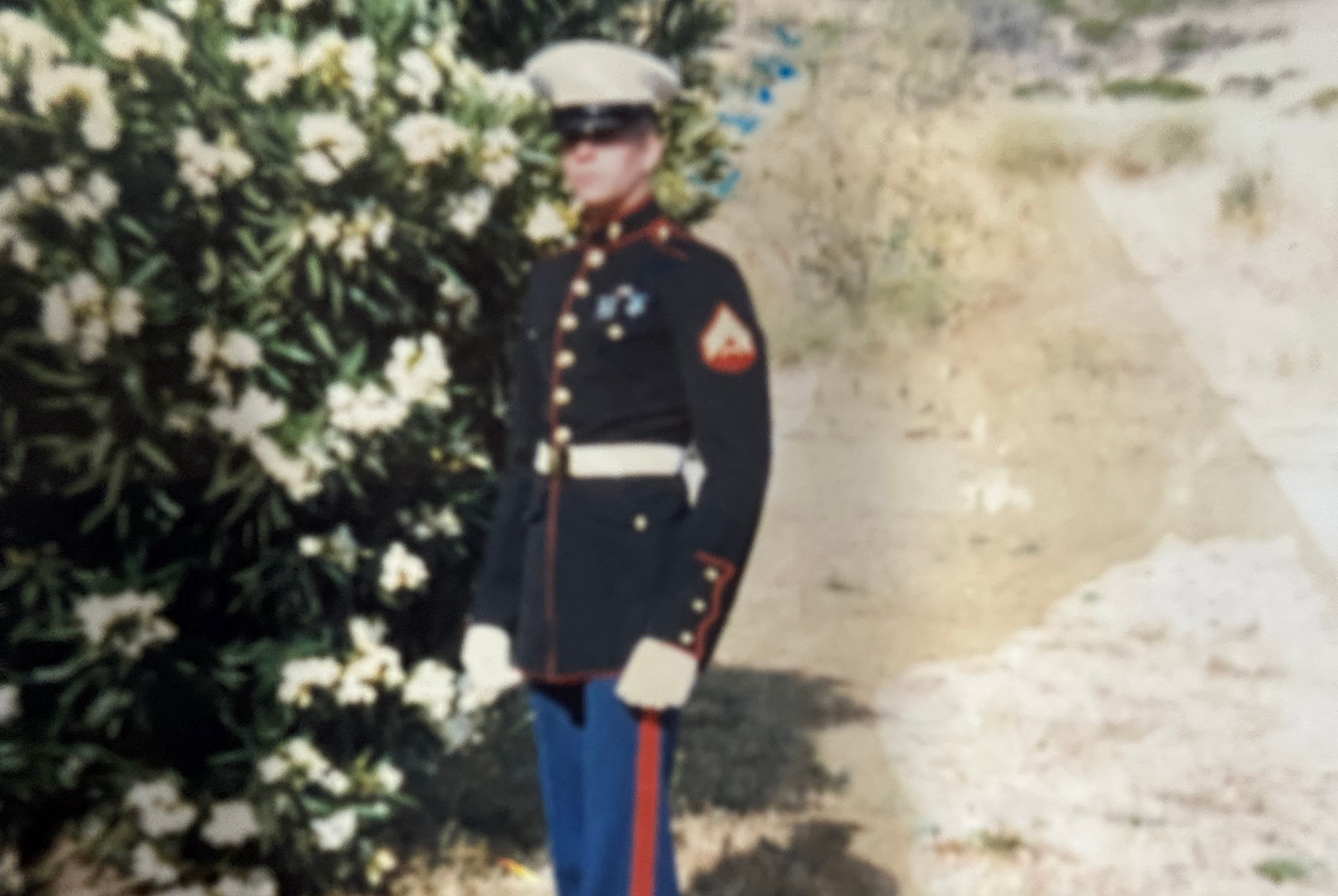A US Marine posing for a photo in his Dress Blues.