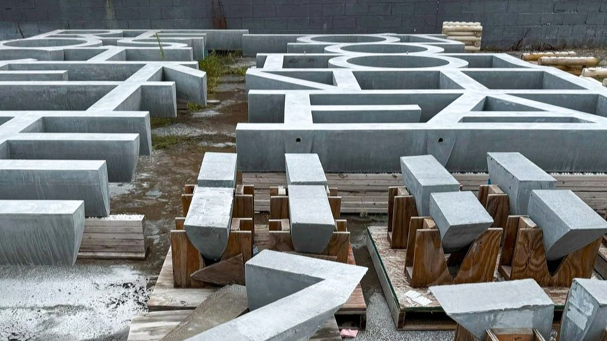 Large precast concrete letters for the Obama Presidential Center exterior facade resting on pallets.