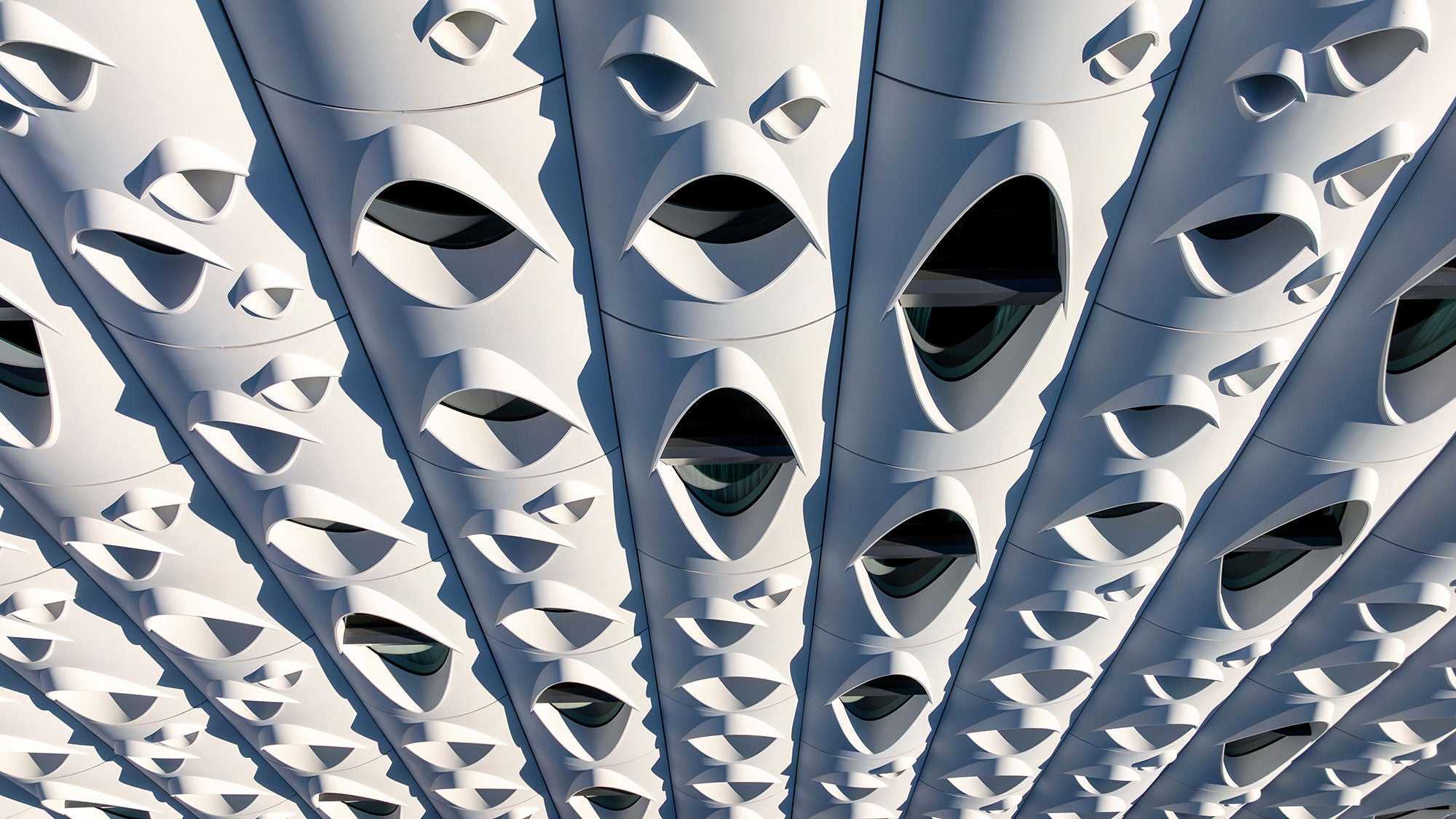 Close-up of Populus’s precast concrete fins, their curved edges casting deep shadows.