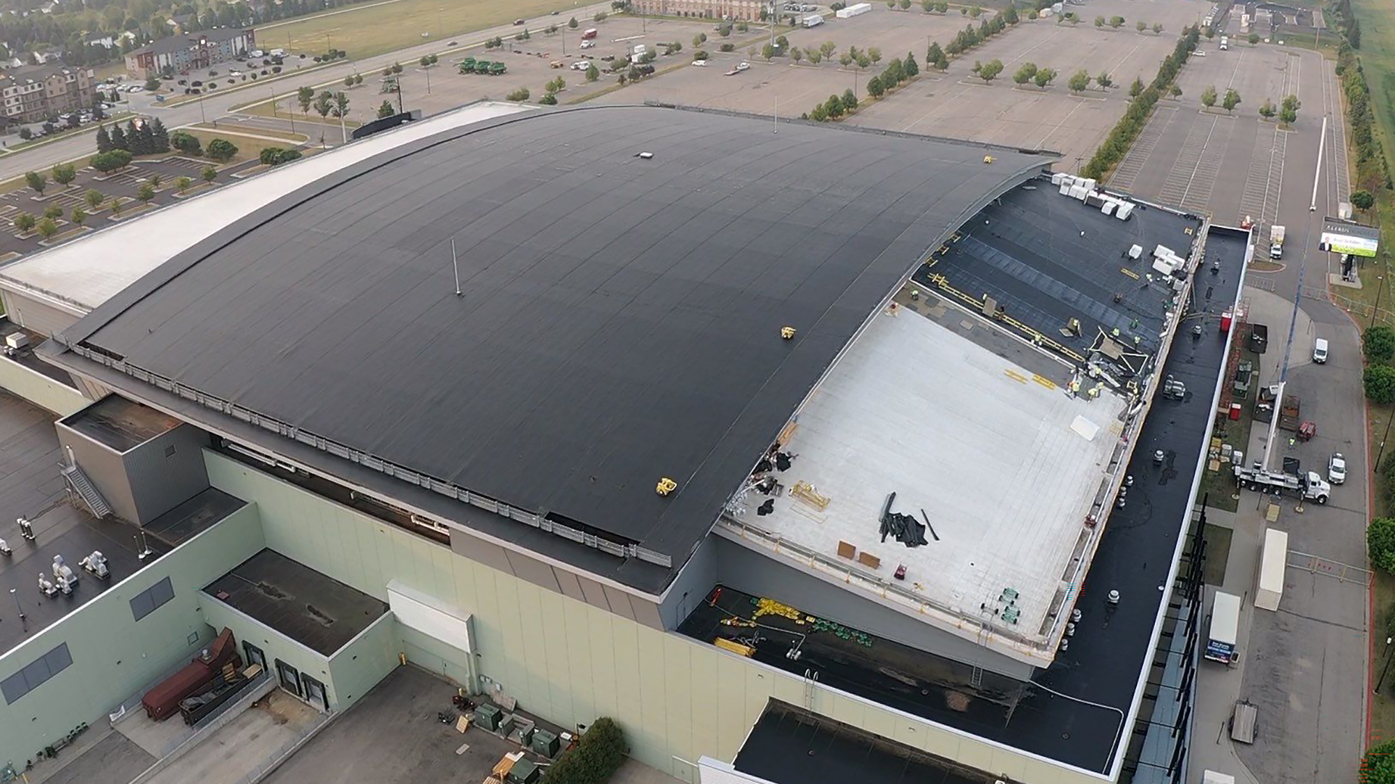 Roofing work takes place on a distinctive, barrel-shaped roof