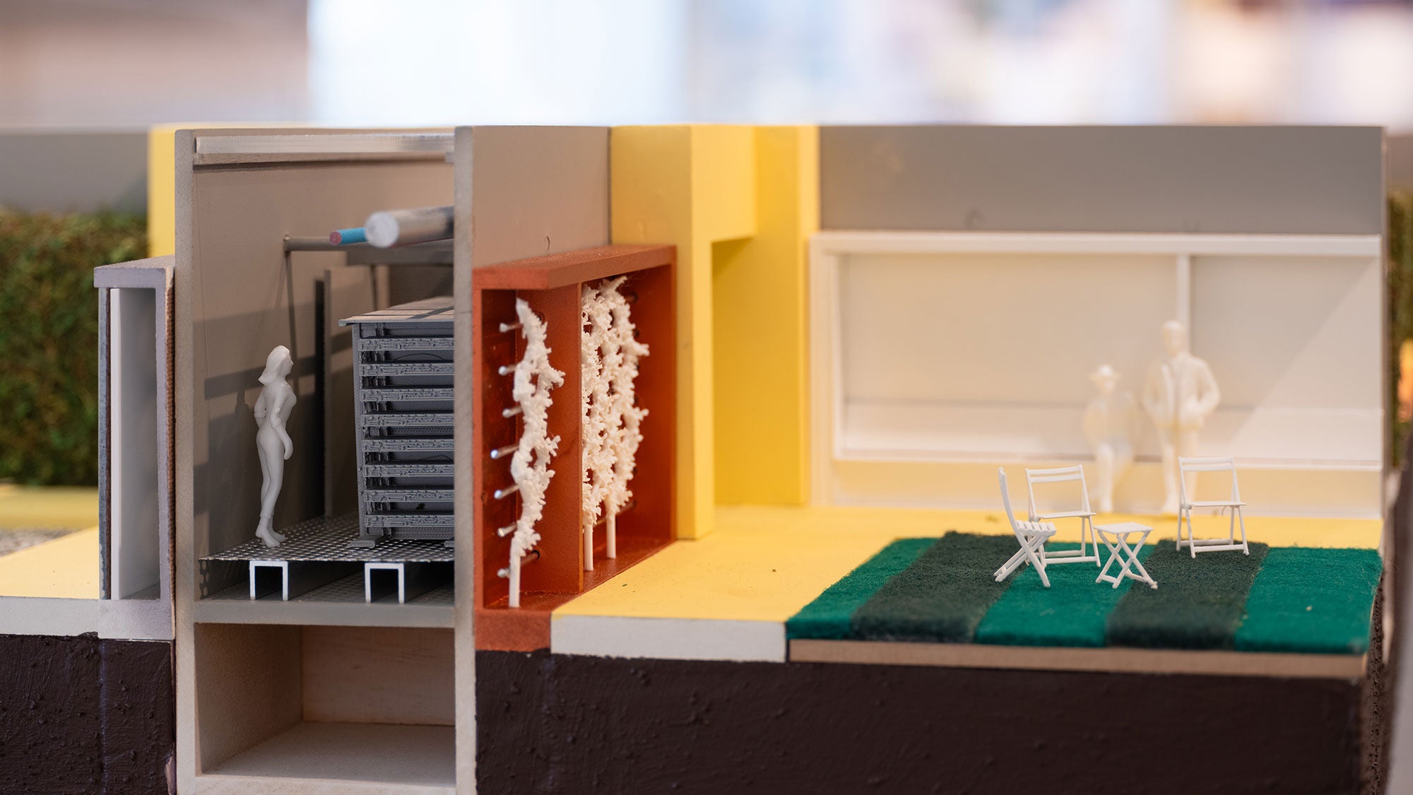 A model of a family home next to a data center showing how heat waste could potentially be used to benefit communities.