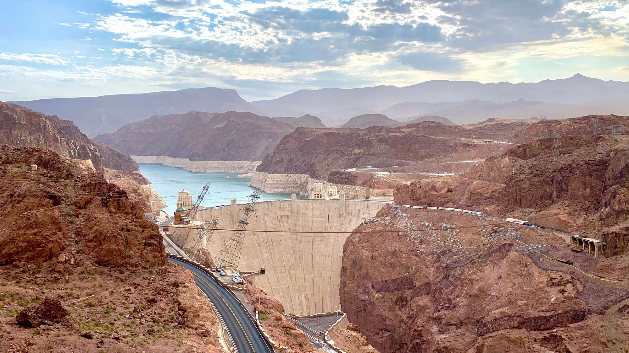 The Hoover Dam as viewed from above, surrounded by orange desert.
