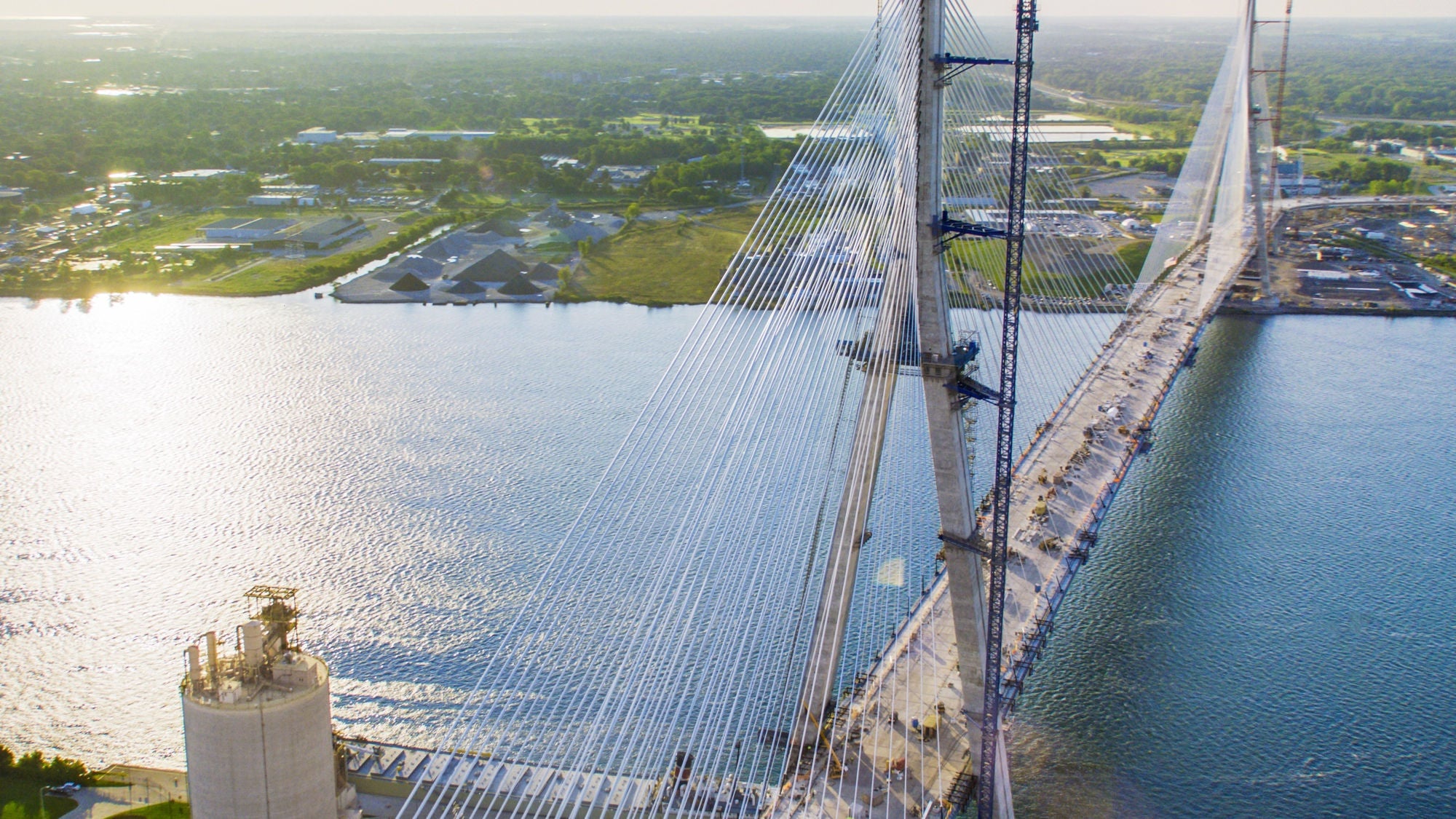  High aerial perspective of the Gordie Howe International Bridge spanning across the Detroit River.