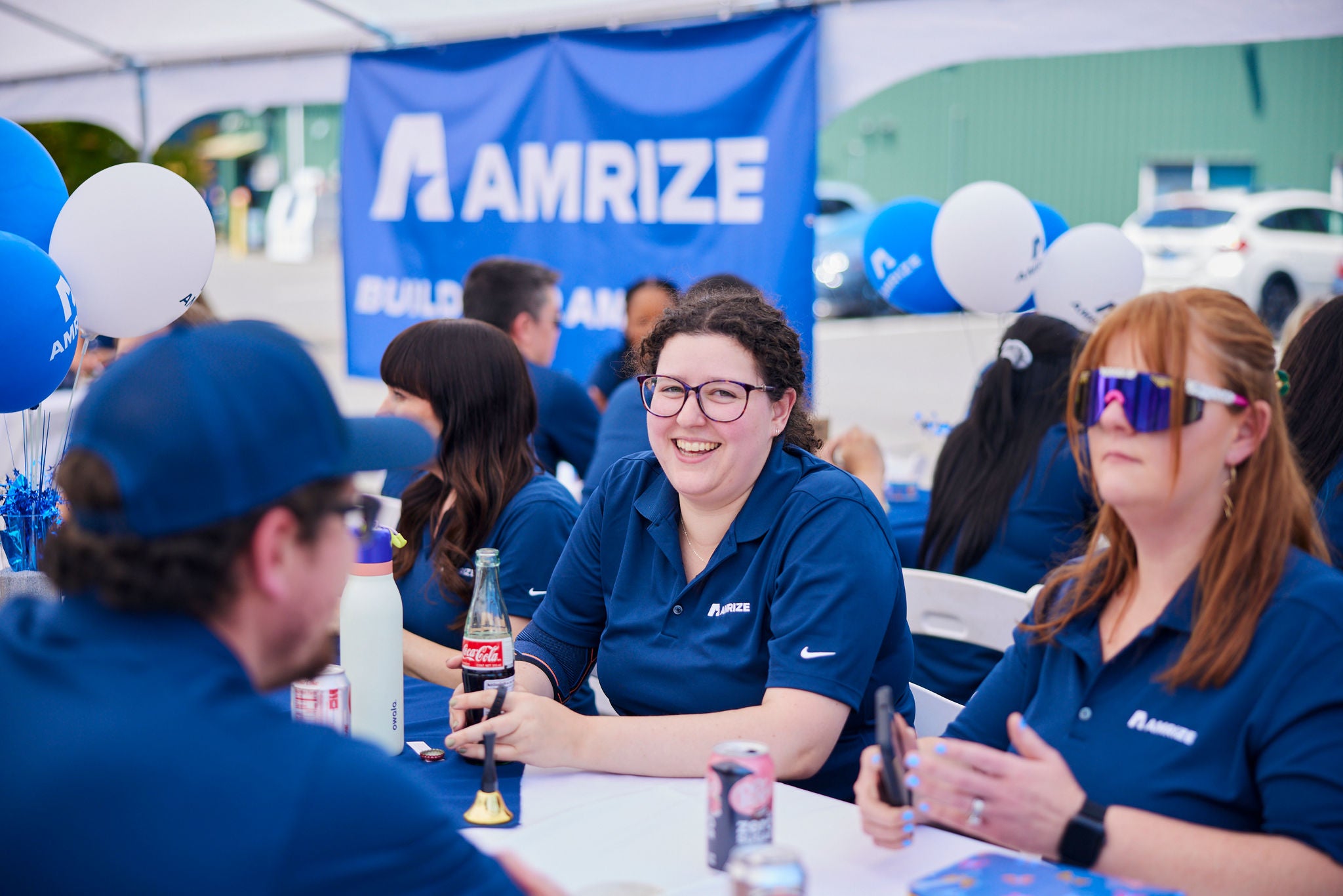Three employees talking at a table